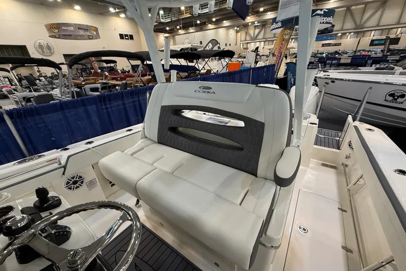 Slide: The Image of 2026 Cobia 305 Center Console boat interior at a boat show display. - 12