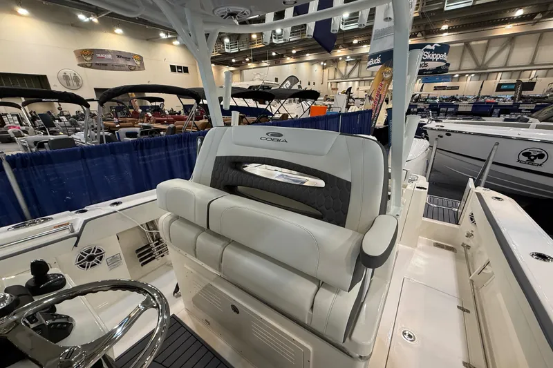 Slide: The Image of 2026 Cobia 305 Center Console boat interior at a boat show display. - 13