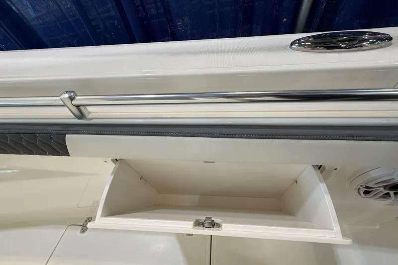 Slide: The Image of 2026 Cobia 305 Center Console boat storage compartment with stainless steel railing. - 14