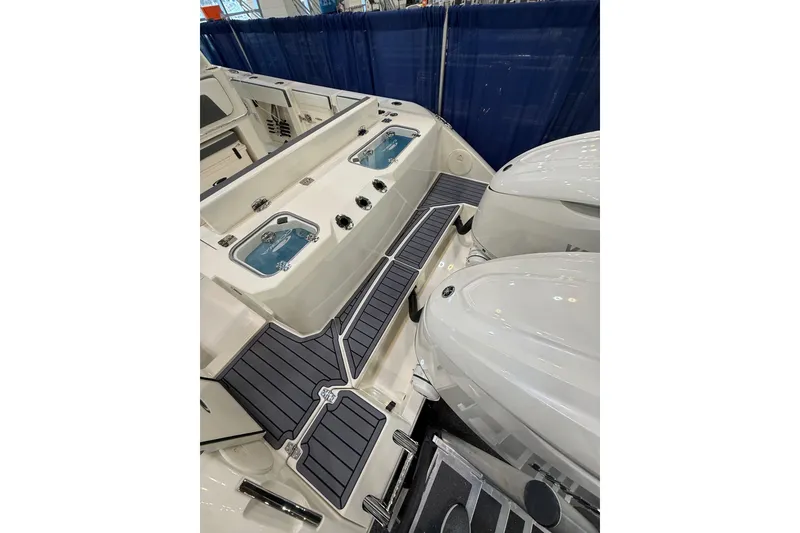 Slide: The Image of 2026 Cobia 305 Center Console boat with dual engines and sleek deck design. - 21
