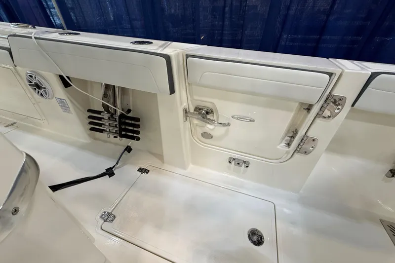 Slide: The Image of 2026 Cobia 305 Center Console boat interior with storage compartments and rod holders. - 7