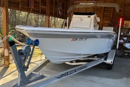 Slide: The Image of 2012 Seafox 220XT boat on trailer in wooden garage setting. - 1