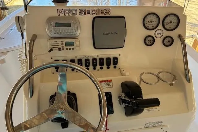 Slide: The Image of 2012 Seafox 220XT boat console with Garmin GPS, gauges, and steering wheel. - 7