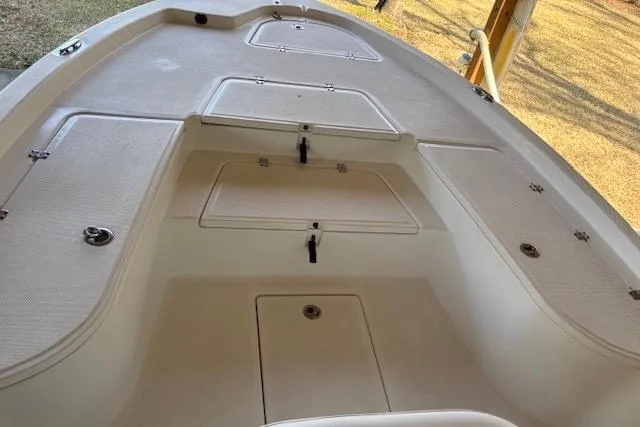 Slide: The Image of 2012 Seafox 220XT boat deck with storage compartments and clean design. - 8