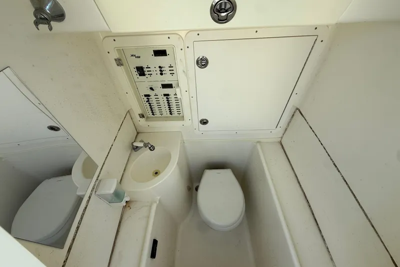 Slide: The Image of 2019 SeaVee 340Z boat interior with toilet, sink, and control panel. - 11