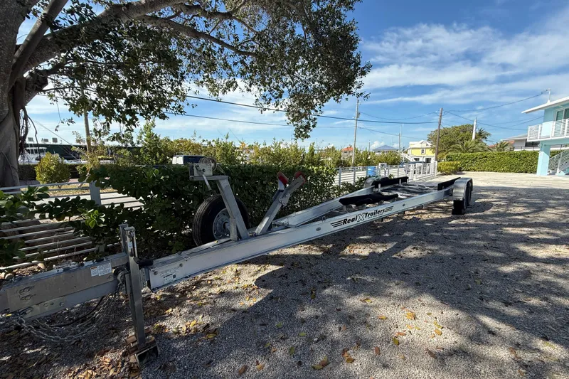 Slide: The Image of Boat trailer for 2019 SeaVee 340Z, parked under a tree on a sunny day. - 13