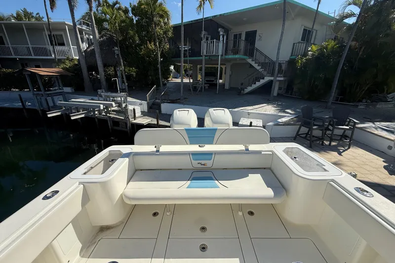 Slide: The Image of 2019 SeaVee 340Z boat docked near a waterfront home with palm trees. - 4