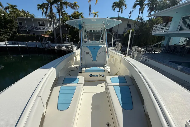 Slide: The Image of 2019 SeaVee 340Z boat with blue and white seating, docked near palm trees. - 9