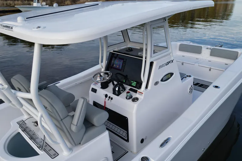 Slide: The Image of 2023 Twin Vee 260 GFX CC boat interior with modern console and seating. - 13