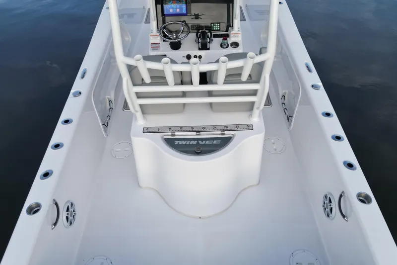 Slide: The Image of 2023 Twin Vee 260 GFX CC boat interior with steering console and rod holders. - 14