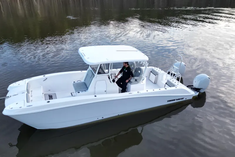 Slide: The Image of 2023 Twin Vee 260 GFX CC boat on calm water, side view. - 20