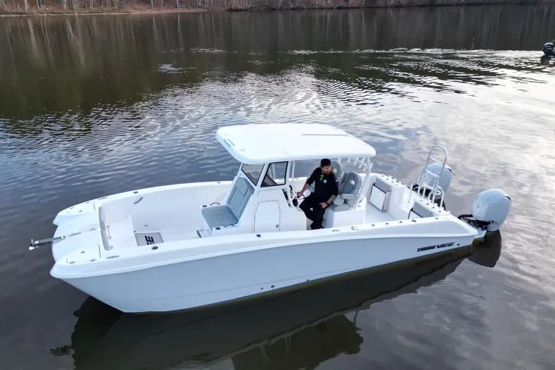 Slide: The Image of 2023 Twin Vee 260 GFX CC boat on calm water, featuring sleek design and modern amenities. - 21