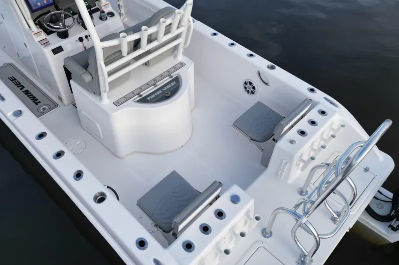 Slide: The Image of 2023 Twin Vee 260 GFX CC boat interior with seating and fishing rod holders. - 4