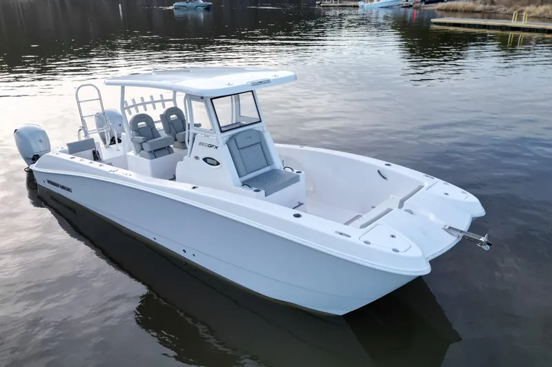 Slide: The Image of 2023 Twin Vee 260 GFX CC boat on calm water, showcasing sleek design and spacious deck. - 5