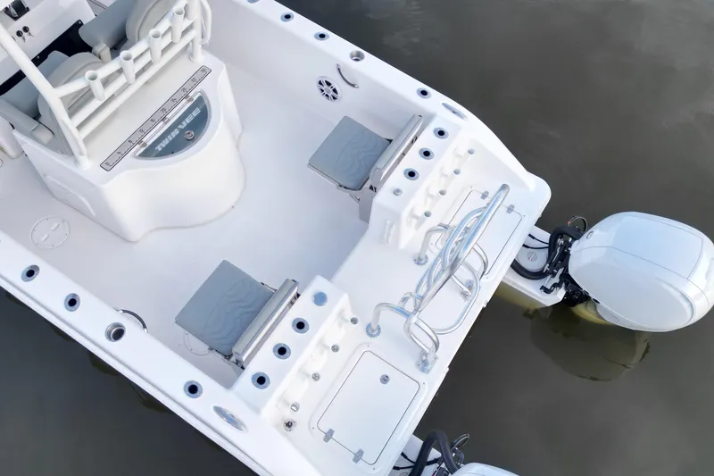 Slide: The Image of 2023 Twin Vee 260 GFX CC boat, featuring spacious deck and modern outboard motor. - 8
