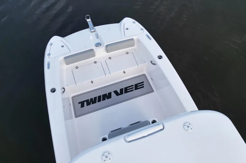 Slide: The Image of 2023 Twin Vee 260 GFX CC boat deck, featuring spacious storage compartments. - 9