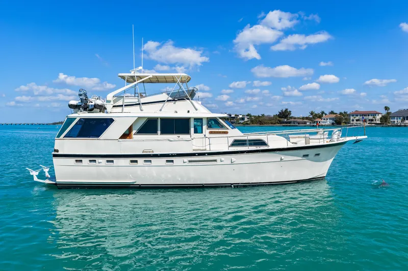 Slide: The Image of 1979 Hatteras 53 Motor Yacht on clear blue water under a sunny sky. - 13