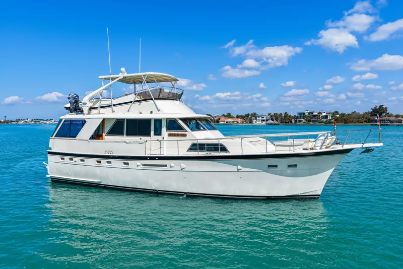 Slide: The Image of 1979 Hatteras 53 Motor Yacht on clear blue water under a sunny sky. - 17