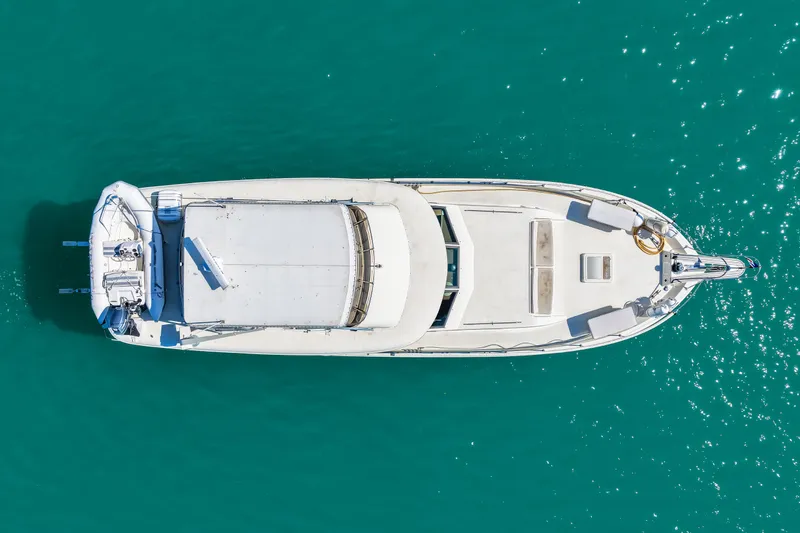 Slide: The Image of Aerial view of 1979 Hatteras 53 Motor Yacht on turquoise water. - 21