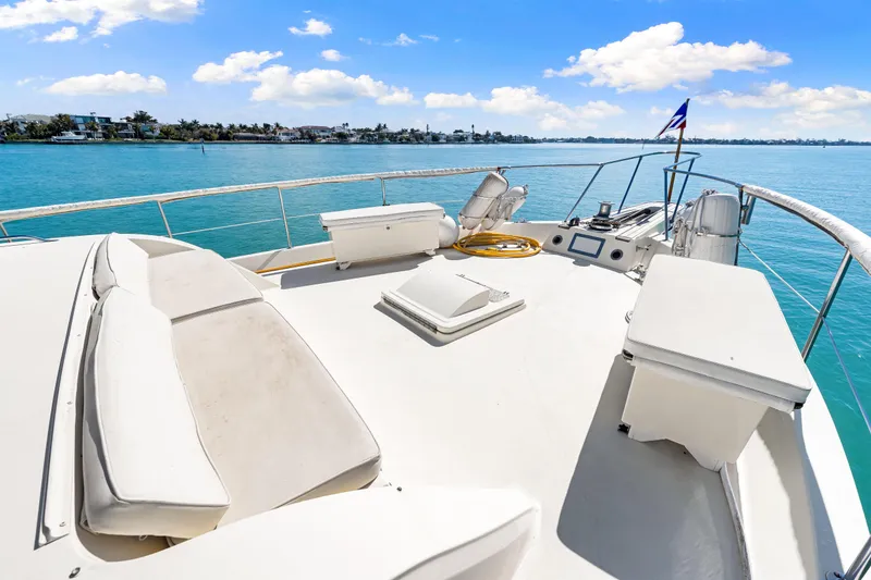 Slide: The Image of 1979 Hatteras 53 Motor Yacht deck with seating, ocean view, and clear blue sky. - 24