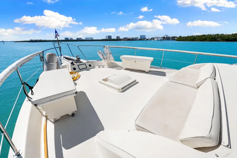 Slide: The Image of 1979 Hatteras 53 Motor Yacht deck with seating, overlooking blue water and skyline. - 25