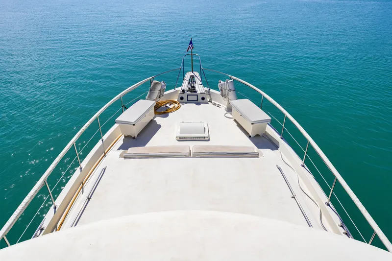 Slide: The Image of 1979 Hatteras 53 Motor Yacht bow view on calm blue water. - 27