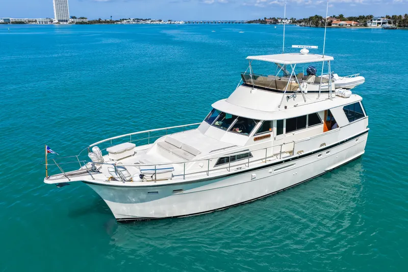 Slide: The Image of 1979 Hatteras 53 Motor Yacht cruising on clear blue water. - 4