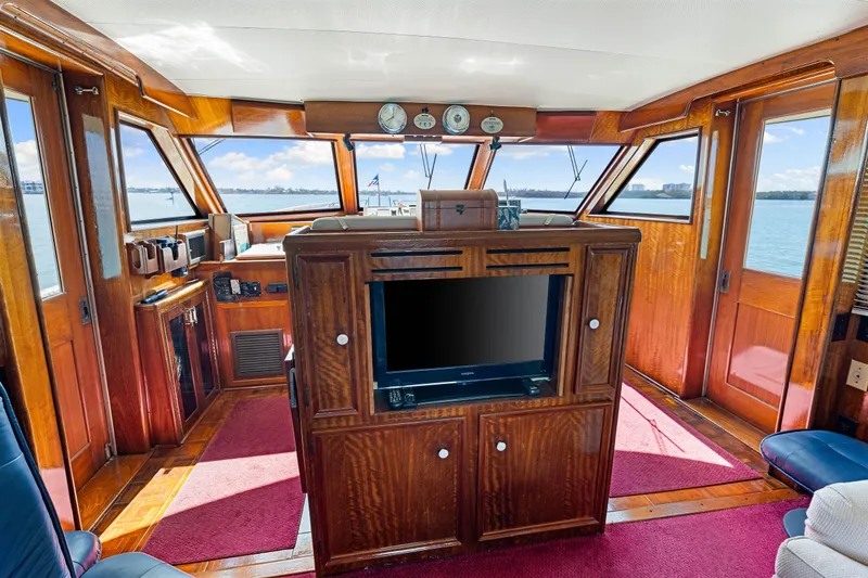 Slide: The Image of Interior of 1979 Hatteras 53 Motor Yacht with wood paneling and large windows. - 41