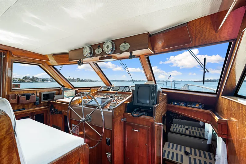 Slide: The Image of 1979 Hatteras 53 Motor Yacht helm with wooden interior and panoramic windows. - 42