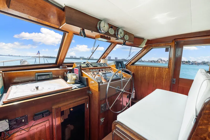 Slide: The Image of Interior helm of 1979 Hatteras 53 Motor Yacht with wooden dashboard and steering wheel. - 43