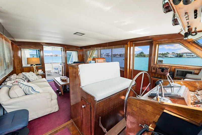 Slide: The Image of Interior of 1979 Hatteras 53 Motor Yacht with elegant wood finish and waterfront view. - 45