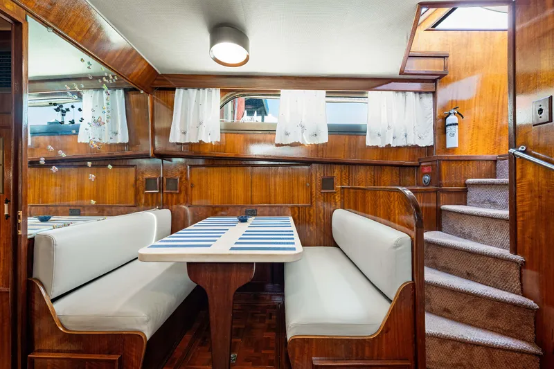 Slide: The Image of Interior of 1979 Hatteras 53 Motor Yacht with dining area and wooden paneling. - 49