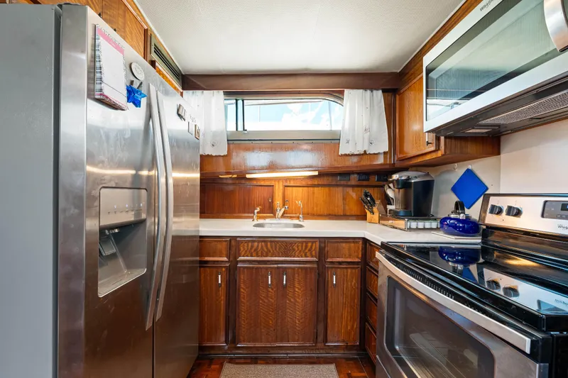 Slide: The Image of 1979 Hatteras 53 Motor Yacht kitchen with stainless steel appliances and wooden cabinetry. - 51