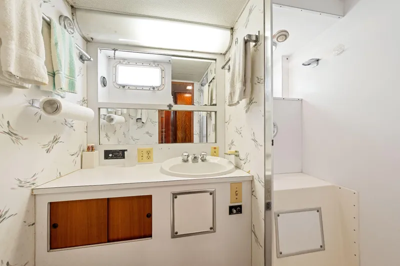 Slide: The Image of 1979 Hatteras 53 Motor Yacht bathroom with sink, mirror, and shower. - 58