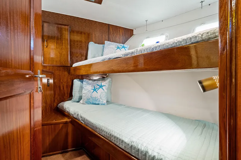 Slide: The Image of 1979 Hatteras 53 Motor Yacht cabin with wooden bunk beds and nautical decor. - 59