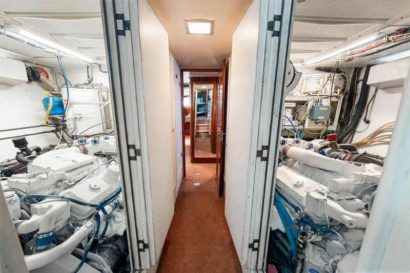Slide: The Image of Engine room of a 1979 Hatteras 53 Motor Yacht, showcasing dual engines and equipment. - 61