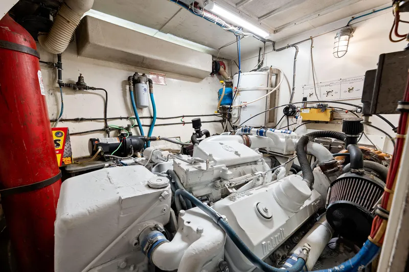 Slide: The Image of Engine room of a 1979 Hatteras 53 Motor Yacht, showcasing mechanical components. - 62