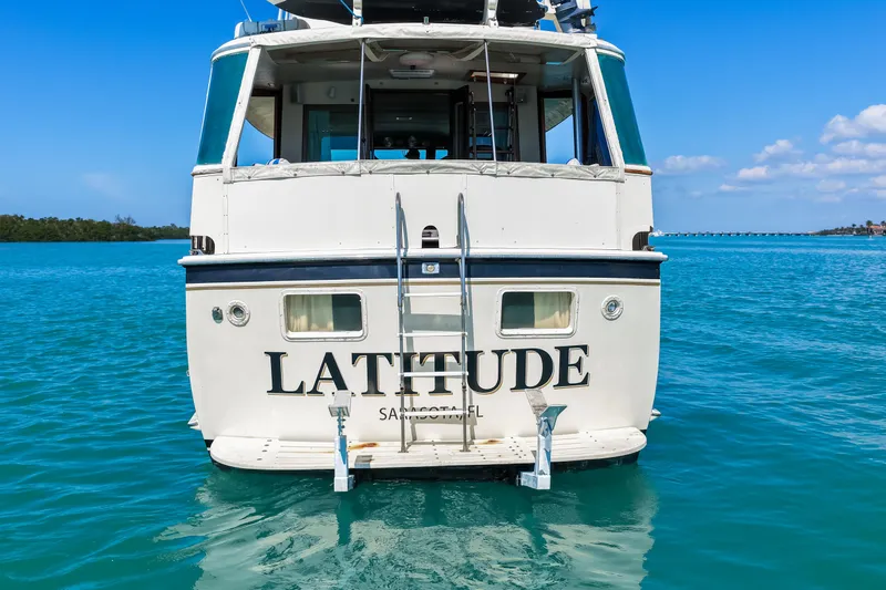 Slide: The Image of 1979 Hatteras 53 Motor Yacht "Latitude" on clear blue water, rear view. - 9