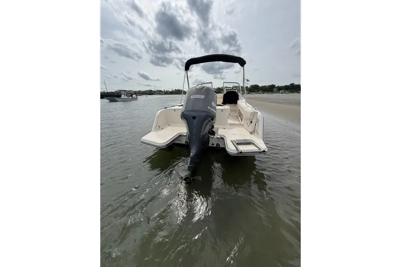 Slide: The Image of 2017 Grady-White Freedom 235 boat in shallow water, rear view with motor. - 13