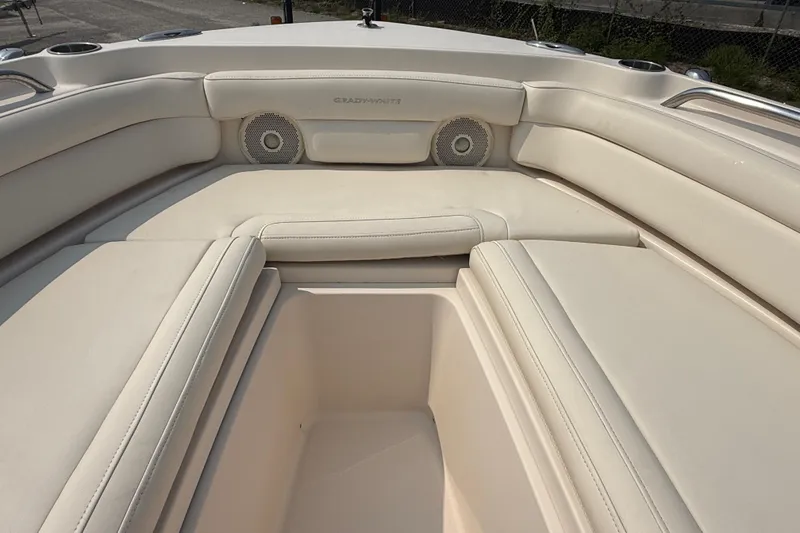 Slide: The Image of 2017 Grady-White Freedom 235 boat interior with beige seating and built-in speakers. - 16