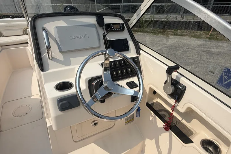 Slide: The Image of 2017 Grady-White Freedom 235 boat helm with Garmin navigation system and steering wheel. - 20