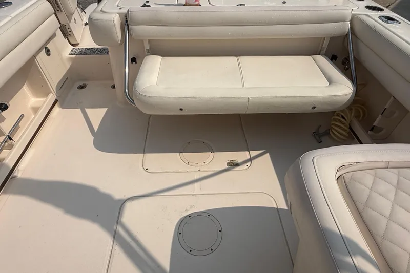 Slide: The Image of 2017 Grady-White Freedom 235 boat interior with beige seating and deck. - 24