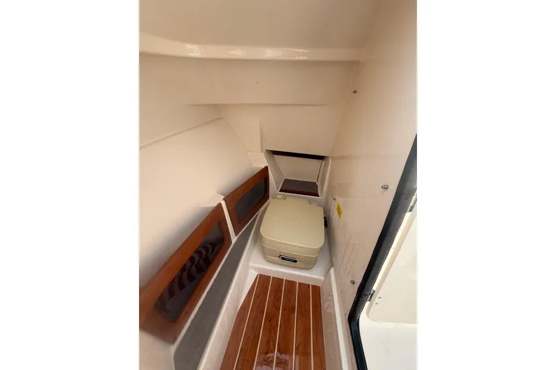 Slide: The Image of 2017 Grady-White Freedom 235 boat interior with wooden flooring and compact seating. - 29