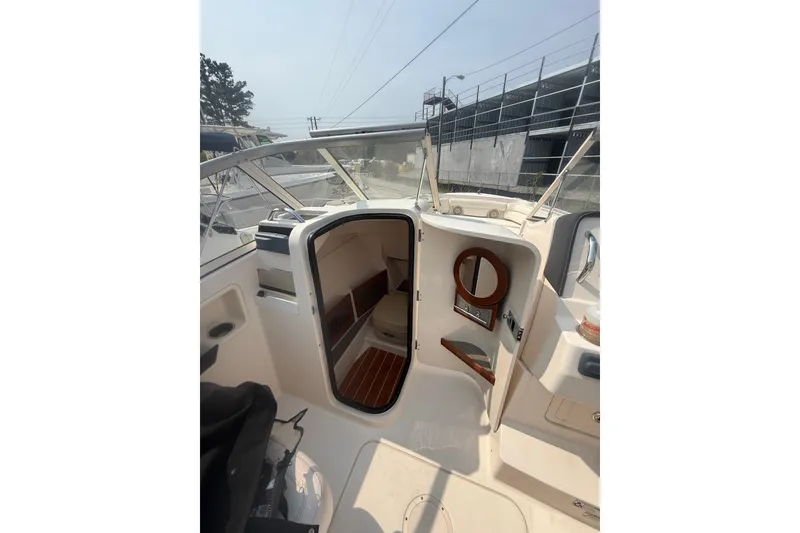 Slide: The Image of 2017 Grady-White Freedom 235 boat interior with cabin and seating area. - 30