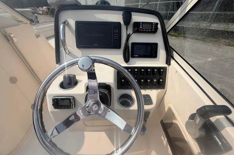 Slide: The Image of 2017 Grady-White Freedom 235 boat dashboard with Garmin navigation system and controls. - 32