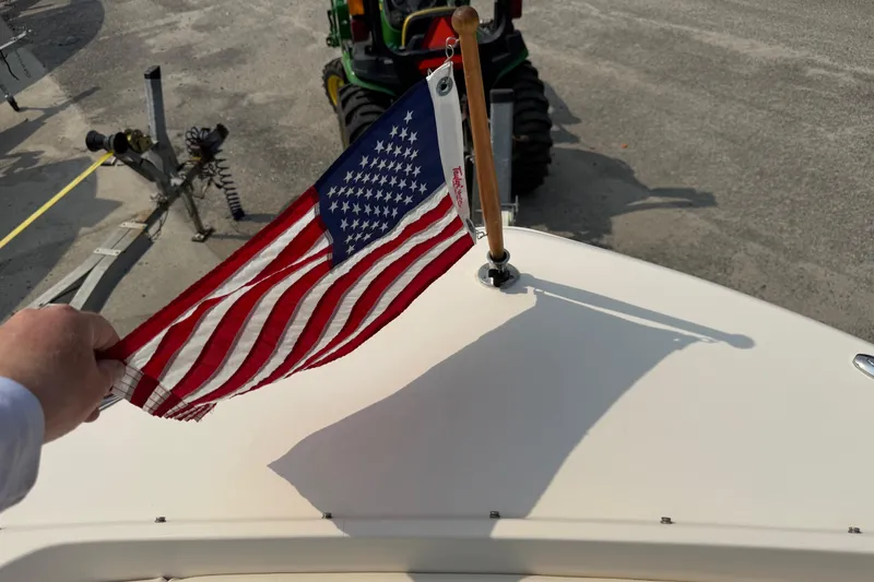 Slide: The Image of 2017 Grady-White Freedom 235 boat with American flag on deck. - 36