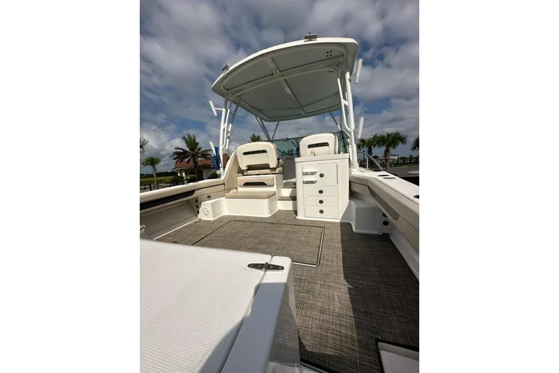 Slide: The Image of 2020 Stamas 326 Aegean boat interior with seating and storage, under a cloudy sky. - 4