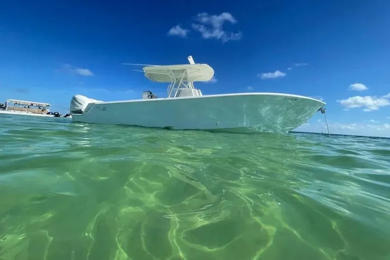 Slide: The Image of 2018 SeaVee 340Z boat anchored in clear turquoise water under a bright blue sky. - 10