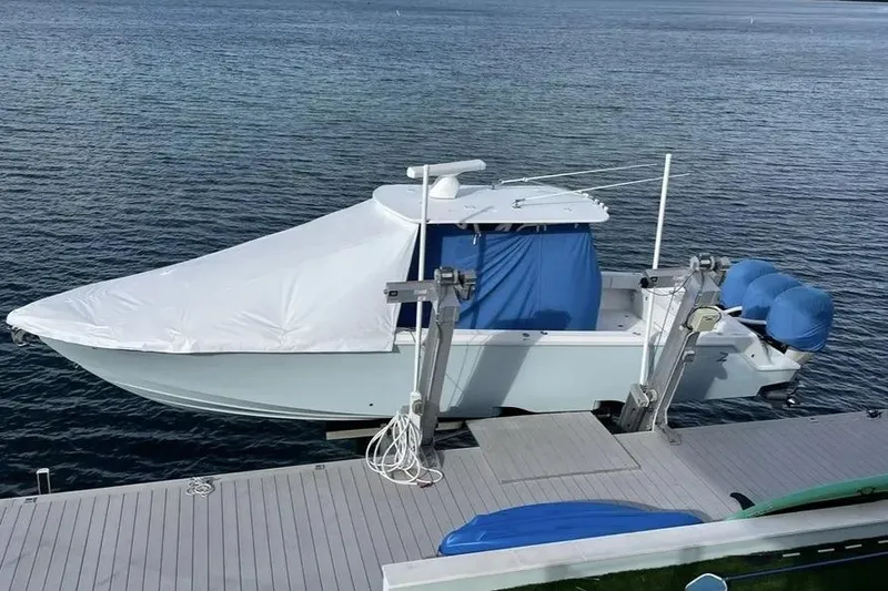 Slide: The Image of 2018 SeaVee 340Z boat docked, covered with white and blue tarps. - 3
