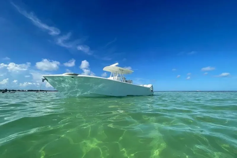 Slide: The Image of 2018 SeaVee 340Z boat floating on clear turquoise water under a bright blue sky. - 8